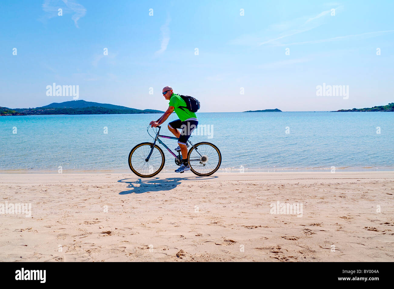 Mann reiten Fahrrad am Strand Stockfoto