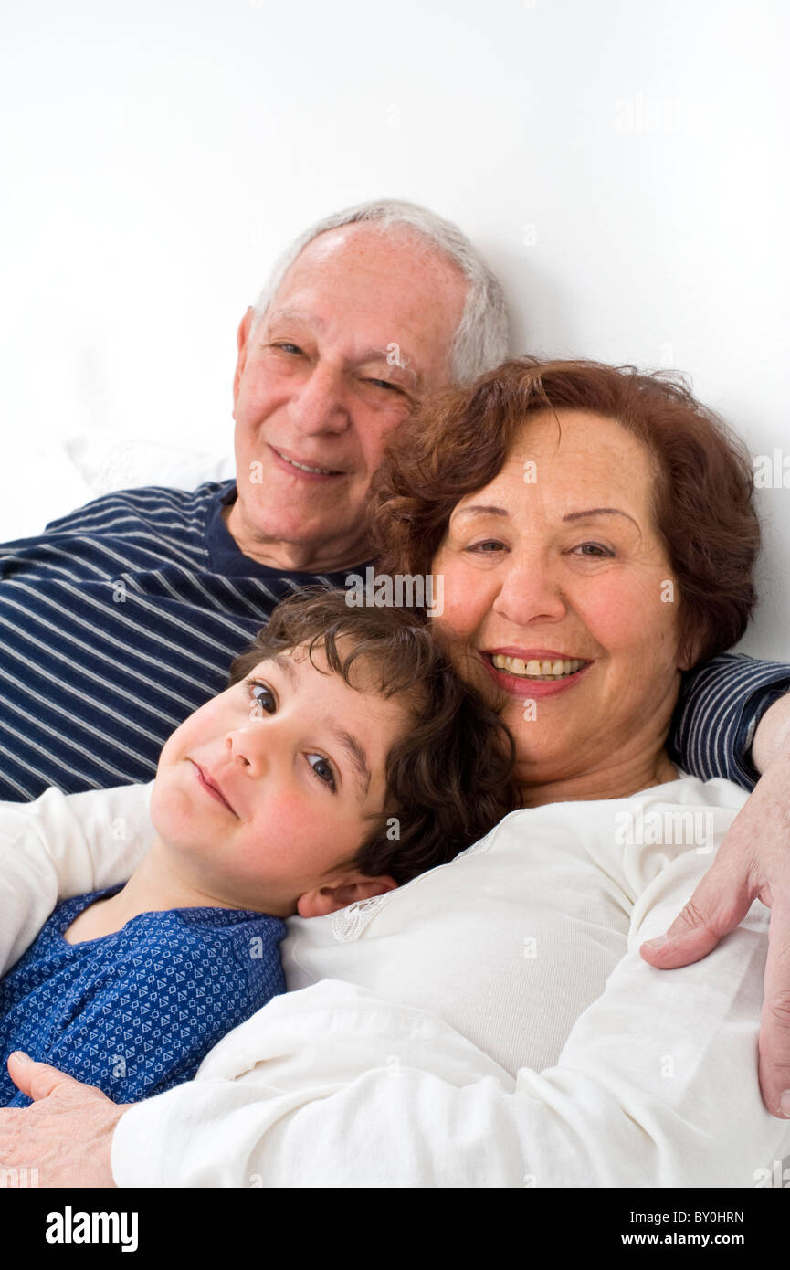 Großeltern und Enkel zusammen im Bett Stockfoto