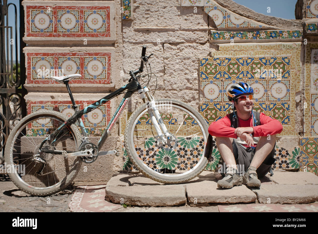 Ein Mann nimmt eine Pause neben seinem Fahrrad ich eine Hazienda in Hidalgo, Mexiko. Stockfoto