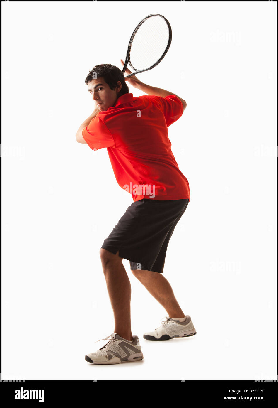Junger Mann mit dem Tennisspielen Stockfoto