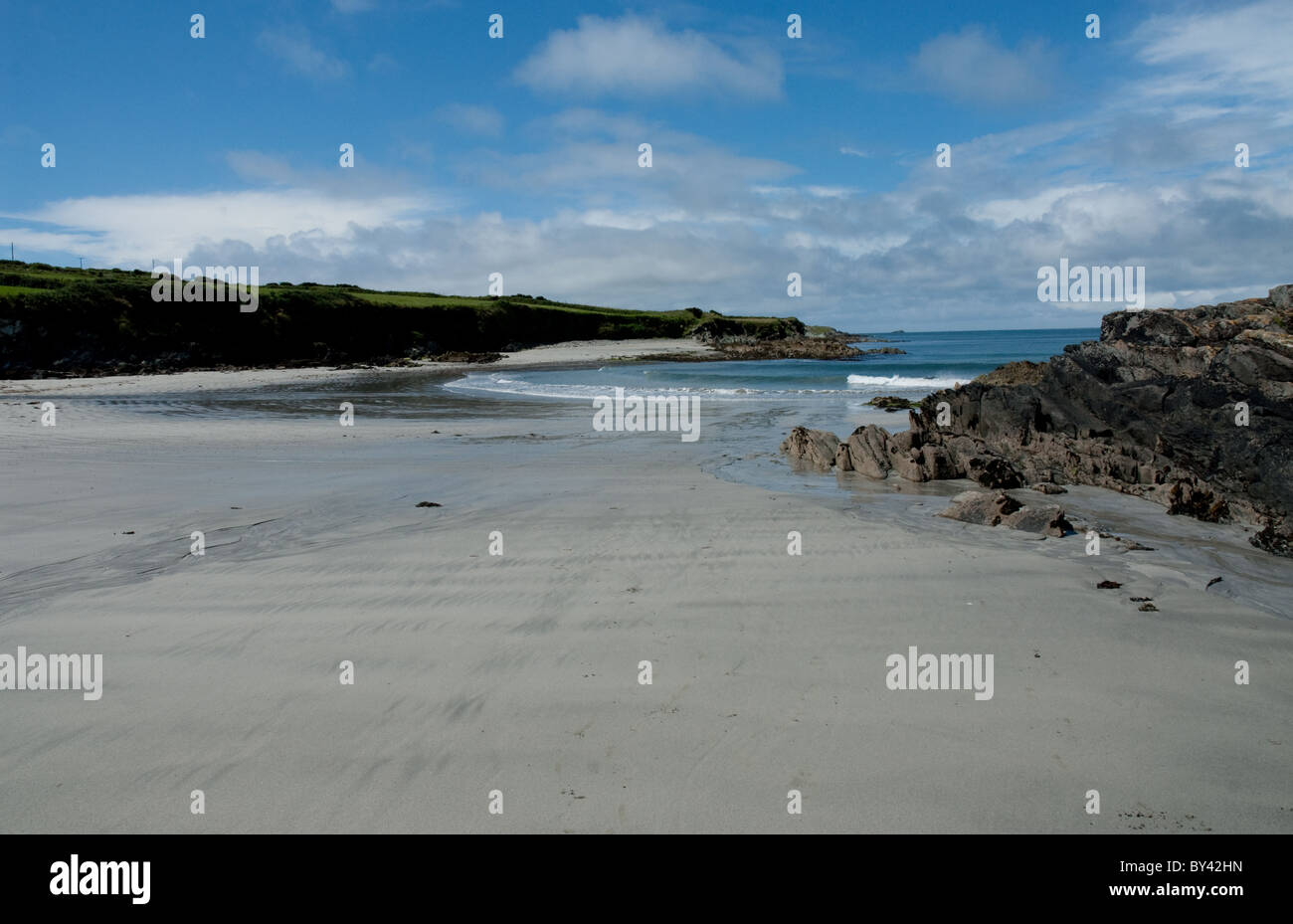 Tra Verbot Strand auf Sherkin Island, Skibbereen, Co Cork, Irland an einem sonnigen Tag mit blauem Himmel. Felsen auf der rechten Seite Stockfoto