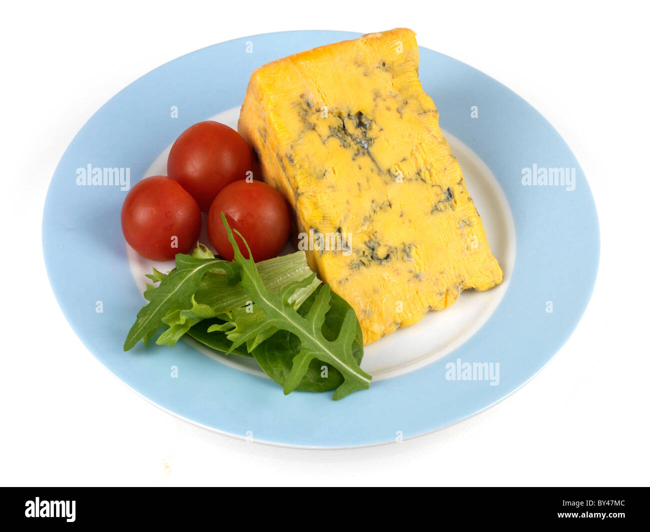 Ein Keil von frischem Blau Shropshire Käse mit Salat mit Kirschtomaten und Rucola Blätter gegen einen weißen Hintergrund mit Keine Personen Stockfoto