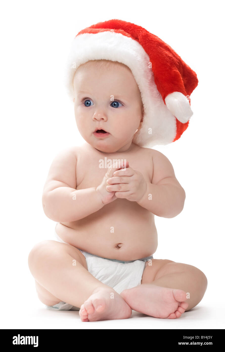 Kleines Baby Santa Cap Blick beiseite mit großen Erstaunen sitzt Stockfoto