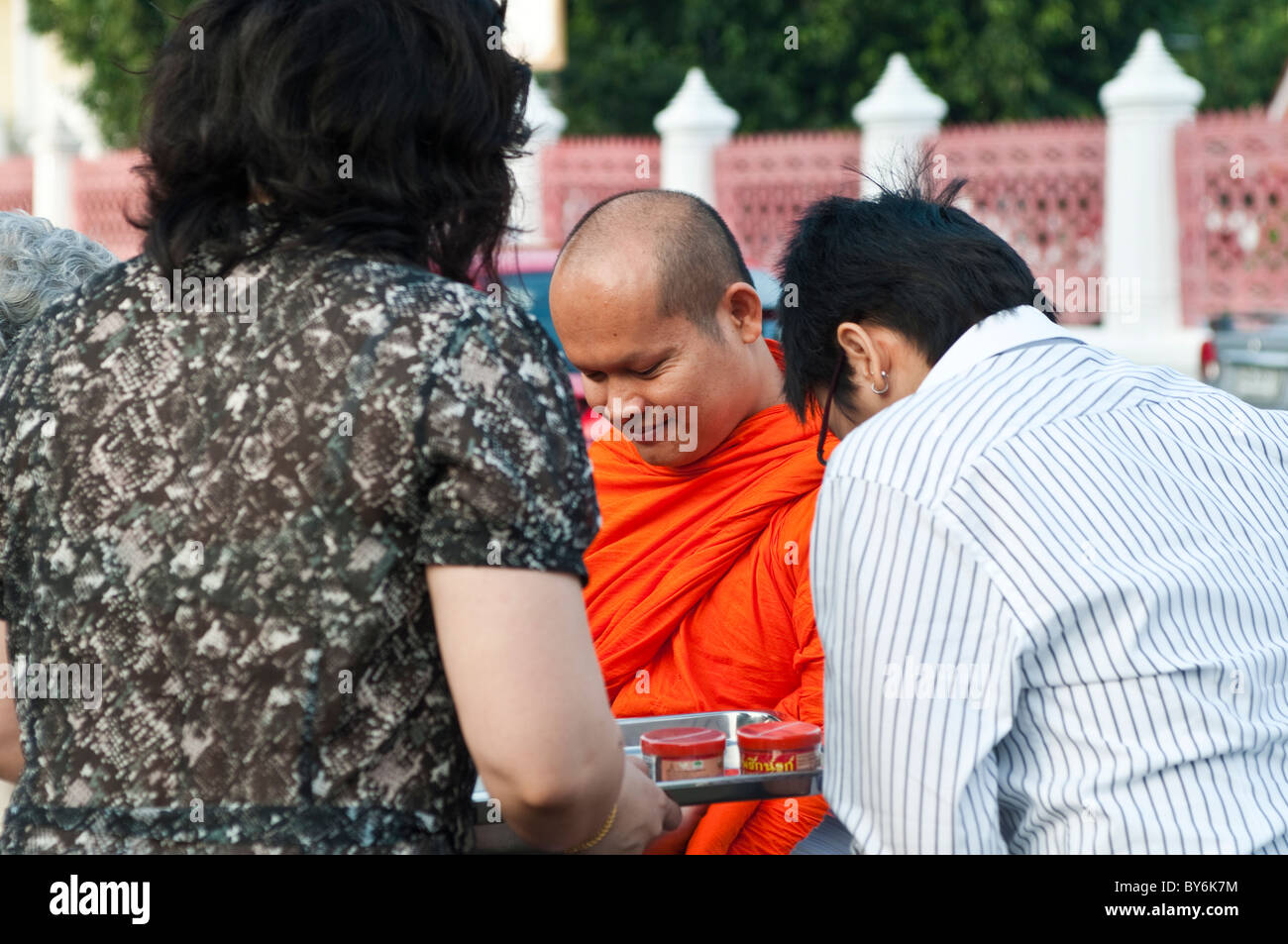 Mönch empfangen Almosen von Verdienst-Machern vor Wat Benjamabophit, Bangkok, Thailand Stockfoto