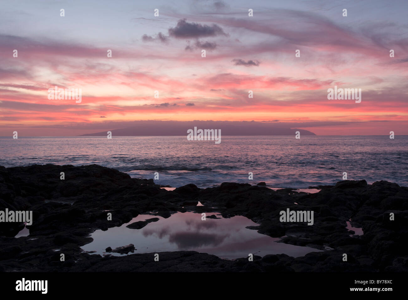 Twilight-Reflexion in einem Felsenpool an der West Küste von Teneriffa mit La Gomera am Horizont Stockfoto