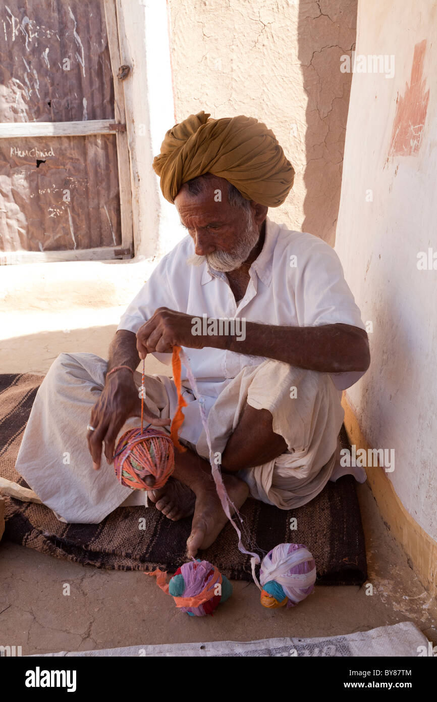 Indien, Rajasthan, Thar-Wüste, Stammesangehörige Wicklung Seil verwendet für die Herstellung von Betten Stockfoto