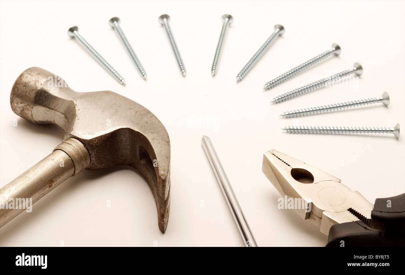 Hammer, Zangen, Schraubenzieher und angeordneten Schrauben. Geschossen Sie auf einem weißen Hintergrund. Stockfoto
