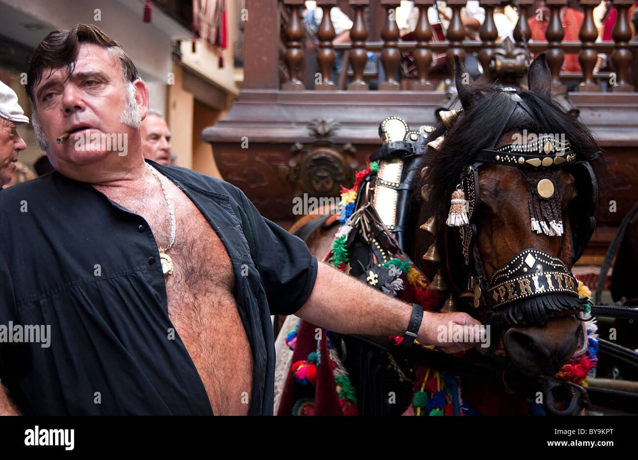 Pferd und Mensch nehmen einen alten Wagen bergauf als einer hundertjährigen Tradition, Fronleichnam zu feiern Stockfoto