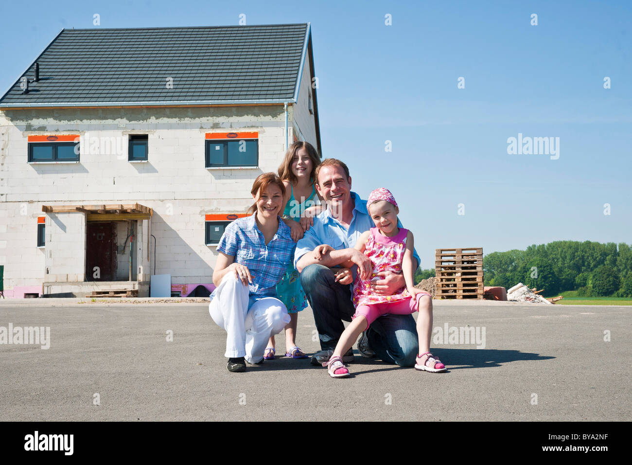 Familie vor ihrem neuen Haus Stockfoto