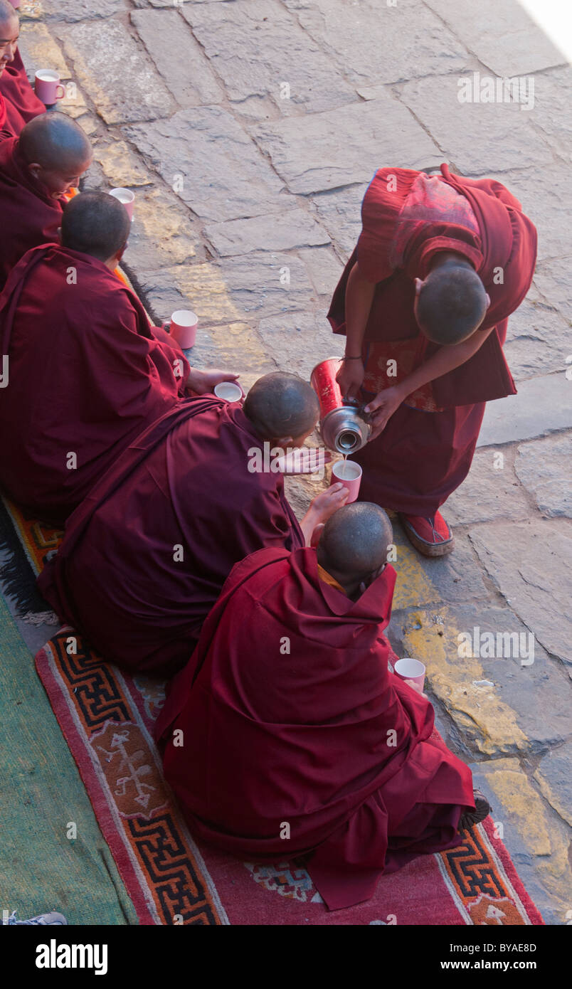 Mönche des Mani Rimdu-Festivals am Kloster Tengboche in der Everest Region Nepals Yak Buttertee serviert wird Stockfoto