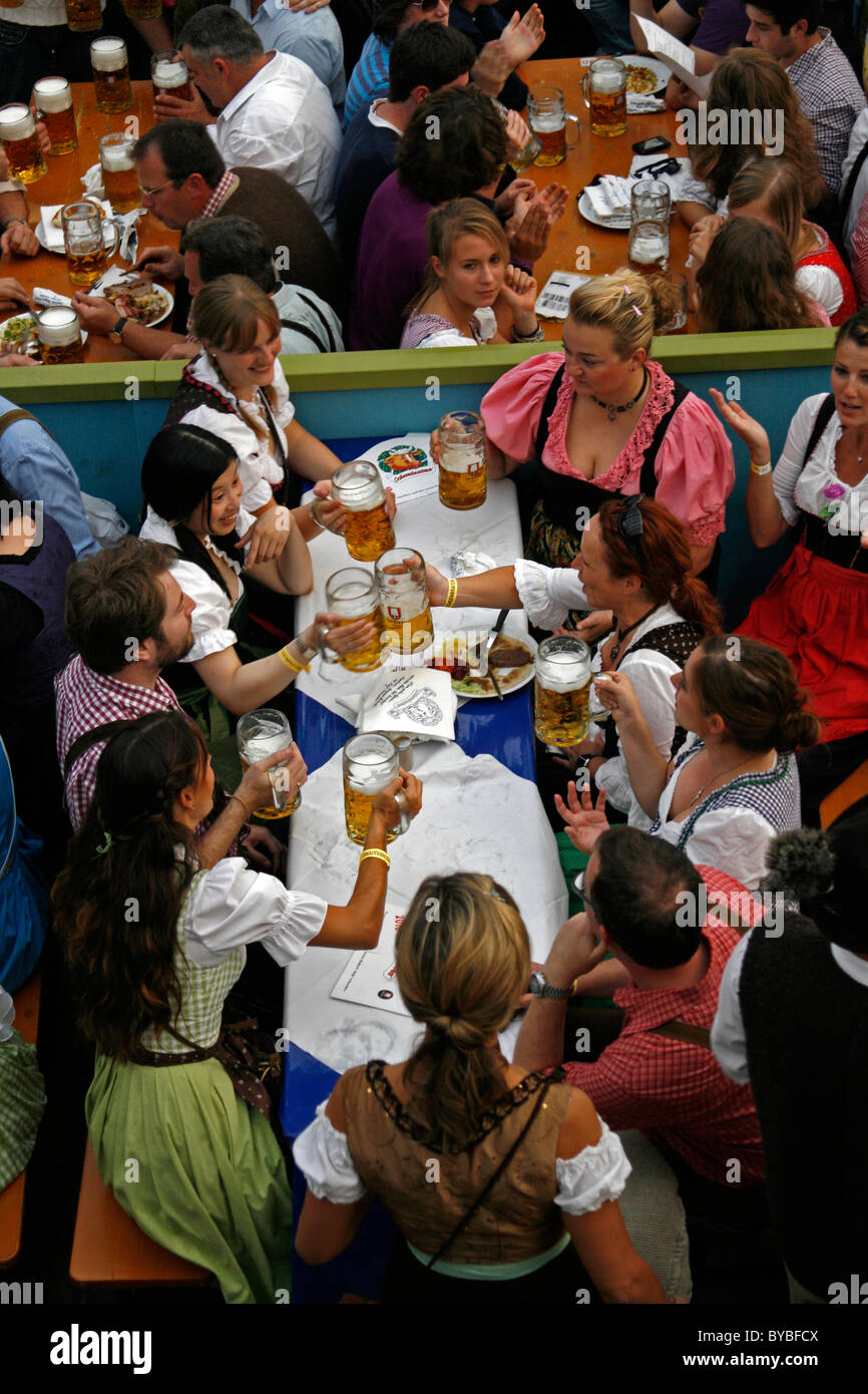 Gruppe von Männern und Frauen in bayrischer Tracht genießen ein Bier in einem Oktoberfest Jugendbund, München, Bayern, Deutschland, Europa Stockfoto