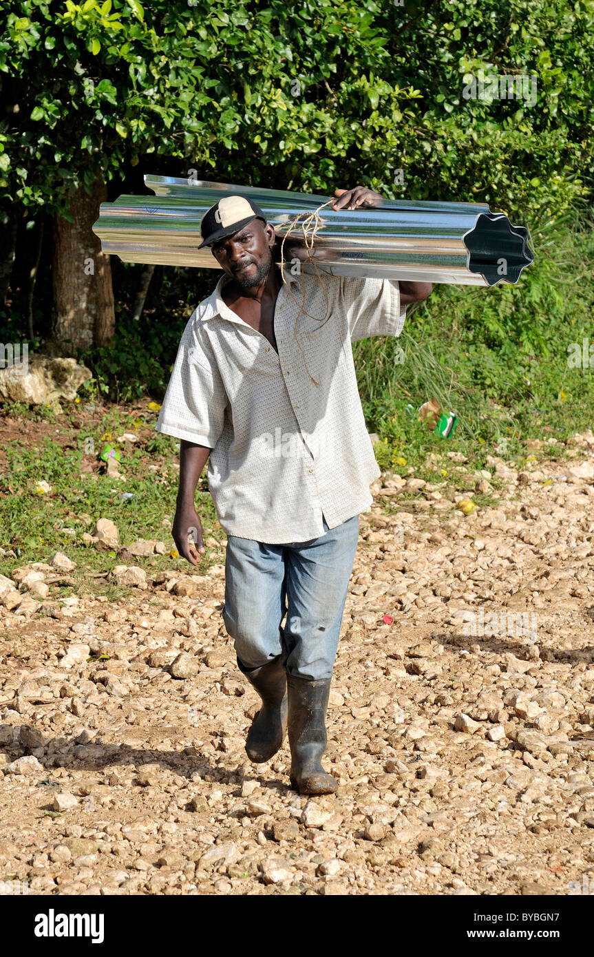 Mann mit Wellblech für Dach. Nach dem schweren Erdbeben im Januar 2010 ist eine deutsche Hilfsorganisationen lokale Ausbildung Stockfoto