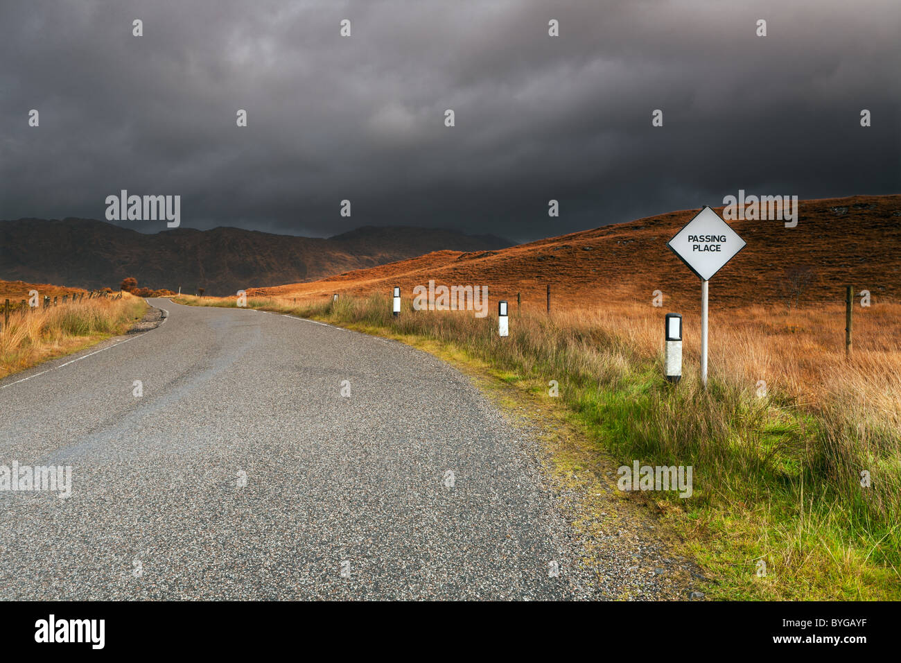 Straßen- und Zeichen auf dem Pass über Glen Moidart mit schweren Himmel in der Ferne droht Stockfoto