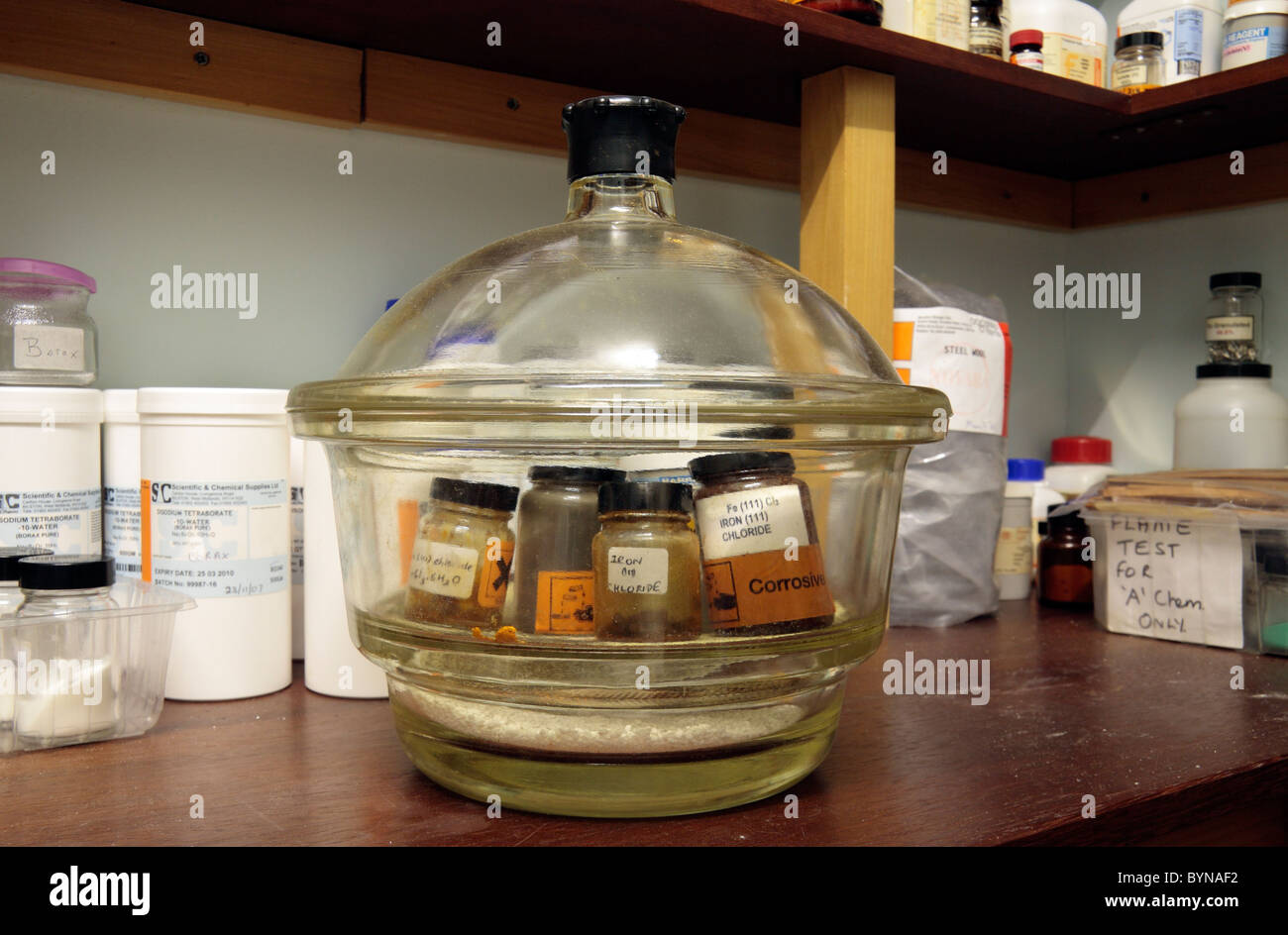 Großen verschlossenen Behältnis (Exsikkator) mit den stark korrosiven Eisen-III-Chlorid in einer Schule Chemikalienlager, London, UK. Stockfoto
