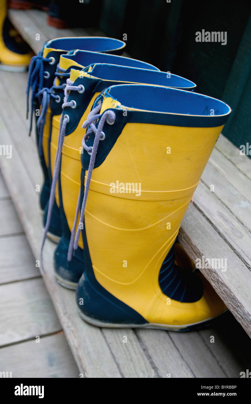 zwei paar gelbe Gummistiefel mit blauen Stutzen; Tofino, Britisch-Kolumbien, Kanada Stockfoto