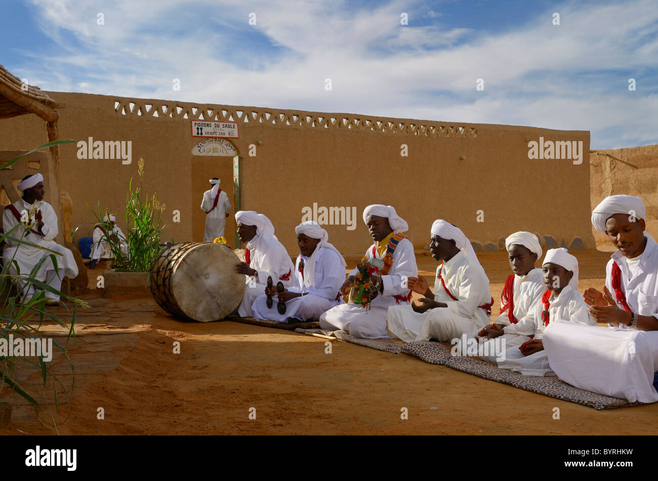 Gruppe der Gnawa-Musiker in weißen Turbanen und Djellabahs sitzen und spielen Musik in Khemliya Dorf Marokko Nordafrika Stockfoto