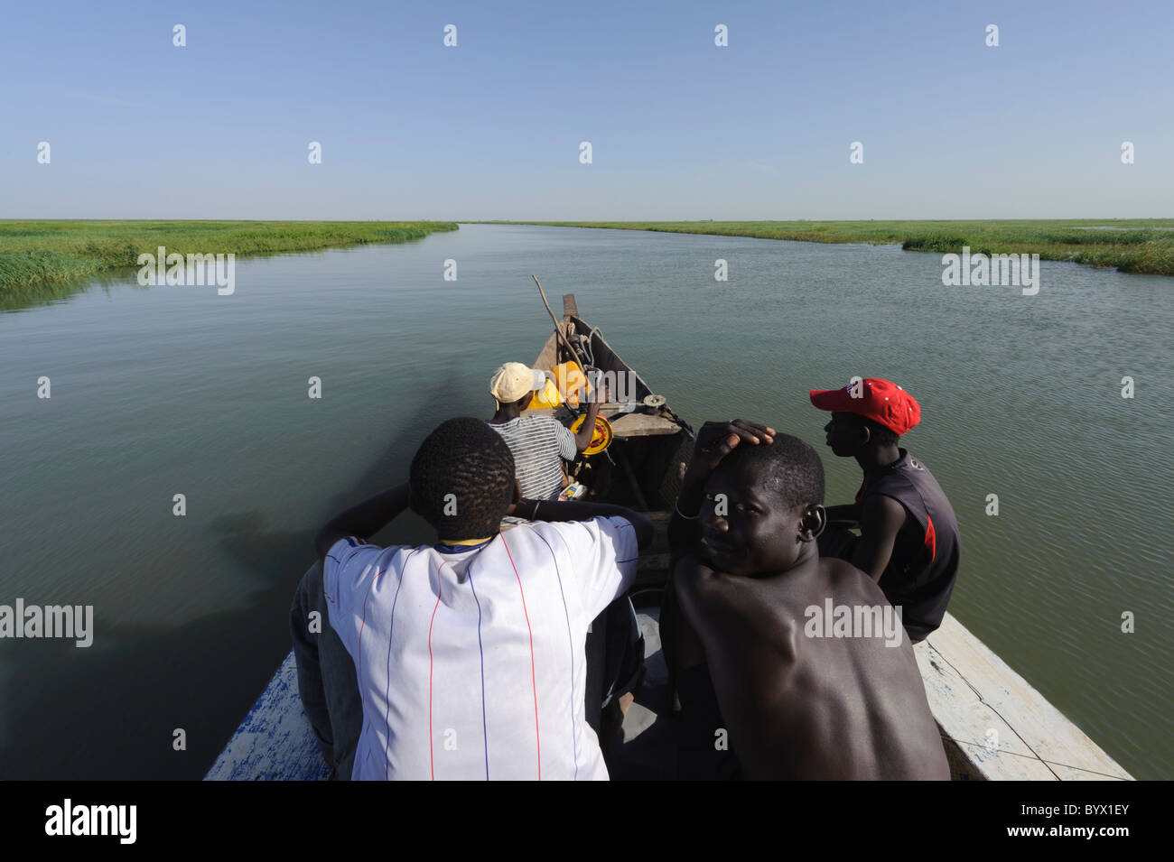 Passagiere und Steuermann sitzt auf der Vorderseite von einer Pinasse cruisen die Niger-Binnendelta. Mali. Stockfoto