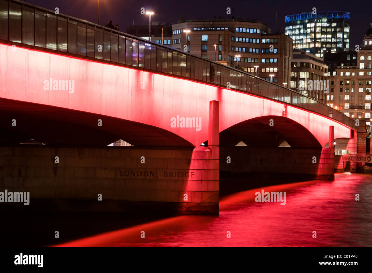 Eine beleuchtete London Bridge nach Einbruch der Dunkelheit, London, England. Stockfoto