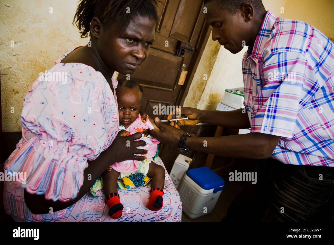 Ein medizinischer Fachkräfte impft ein Kind gegen Masern im Gesundheitszentrum Binkolo Gemeinschaft in Binkolo, Sierra Leone Stockfoto