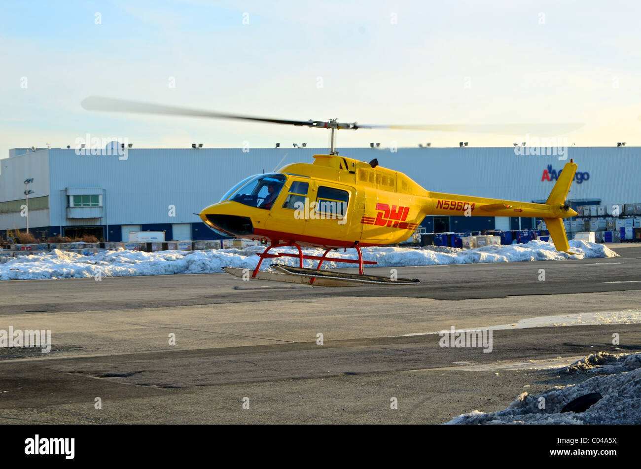 Bell 206 Hubschrauber in DHL-Lackierung, die Landung am Flughafen New York JFK, Dokumente für die Lieferung an die Wall Street Manhattans zu sammeln Stockfoto
