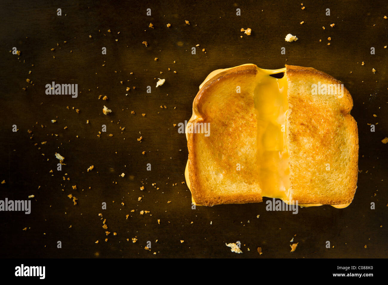 Ein gegrilltes Käsesandwich halbieren ziehen den Käse auf einem Holztisch Stockfoto