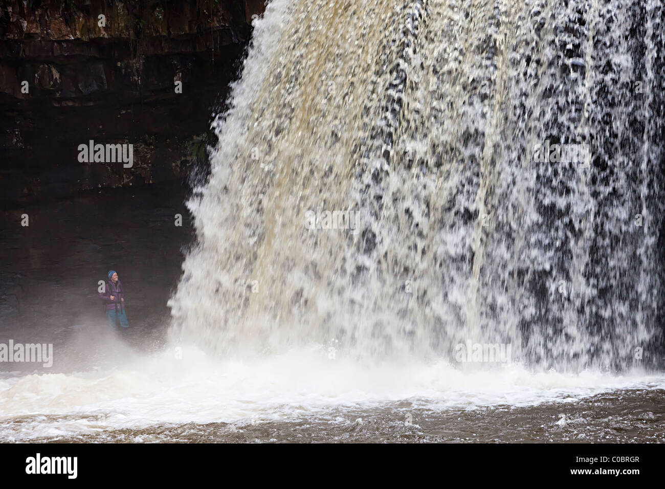 Sgwd Gwladus Wasserfall mit Person steht im Spray Wasserfällen gehen Powys Wales UK Stockfoto