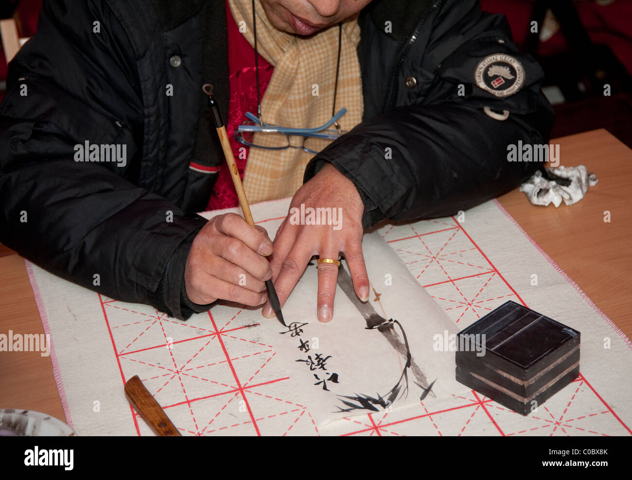 Paris, Frankreich - 12. Februar 2011 - ein Mann zeigen, zeigen chinesischen Kalligraphie Stockfoto