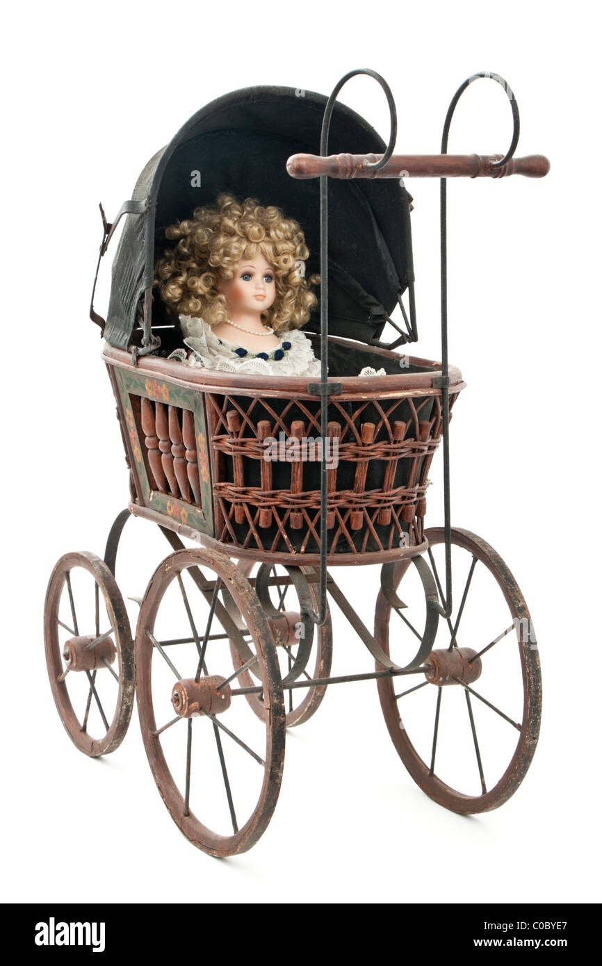 Antike viktorianische Puppen Kinderwagen mit Porzellanpuppe in Stockfoto