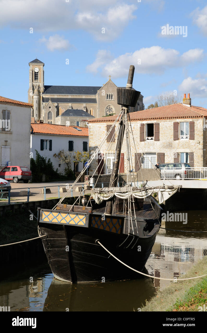 Französisches Schiff Replik auf Kanal und Kirche von Talmont Saint Hilaire in der Vendee Region des westlichen Frankreich EU Stockfoto