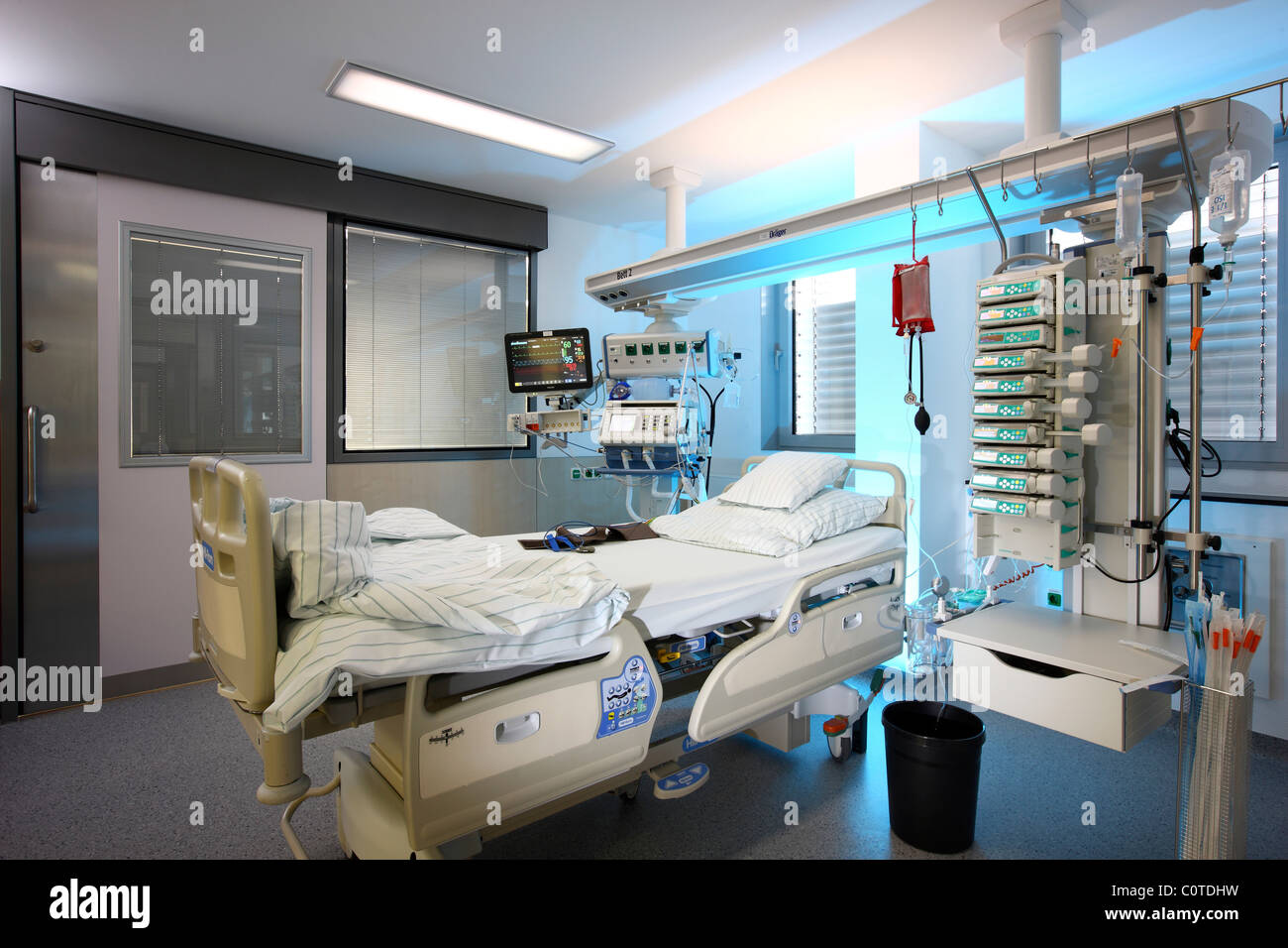 Intensivstation in einem Krankenhaus. Ein Patient wird mit verschiedenen lebenserhaltenden Systemen verbunden. Stockfoto