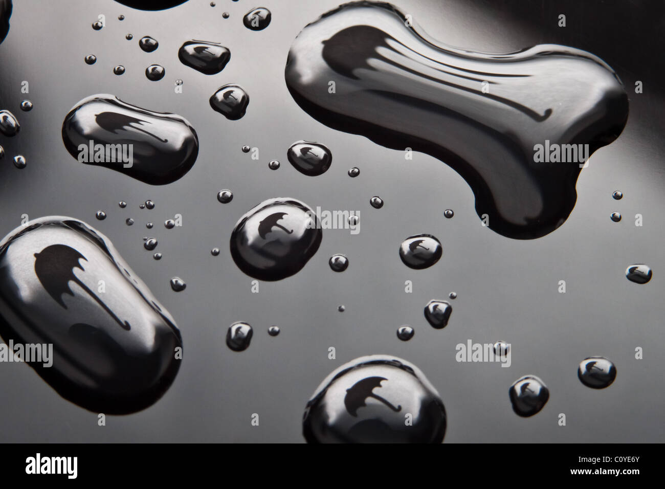 Wassertropfen mit Regenschirm Form auf schwarzem Hintergrund. Stockfoto