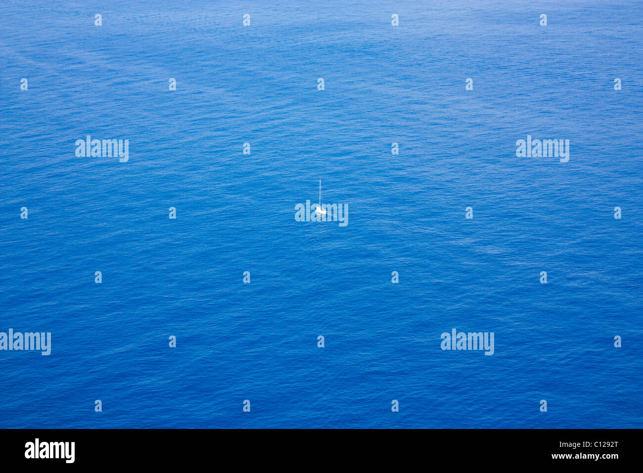 Foto von einzelnen Boot Segeln in einem weiten Ozean Stockfoto