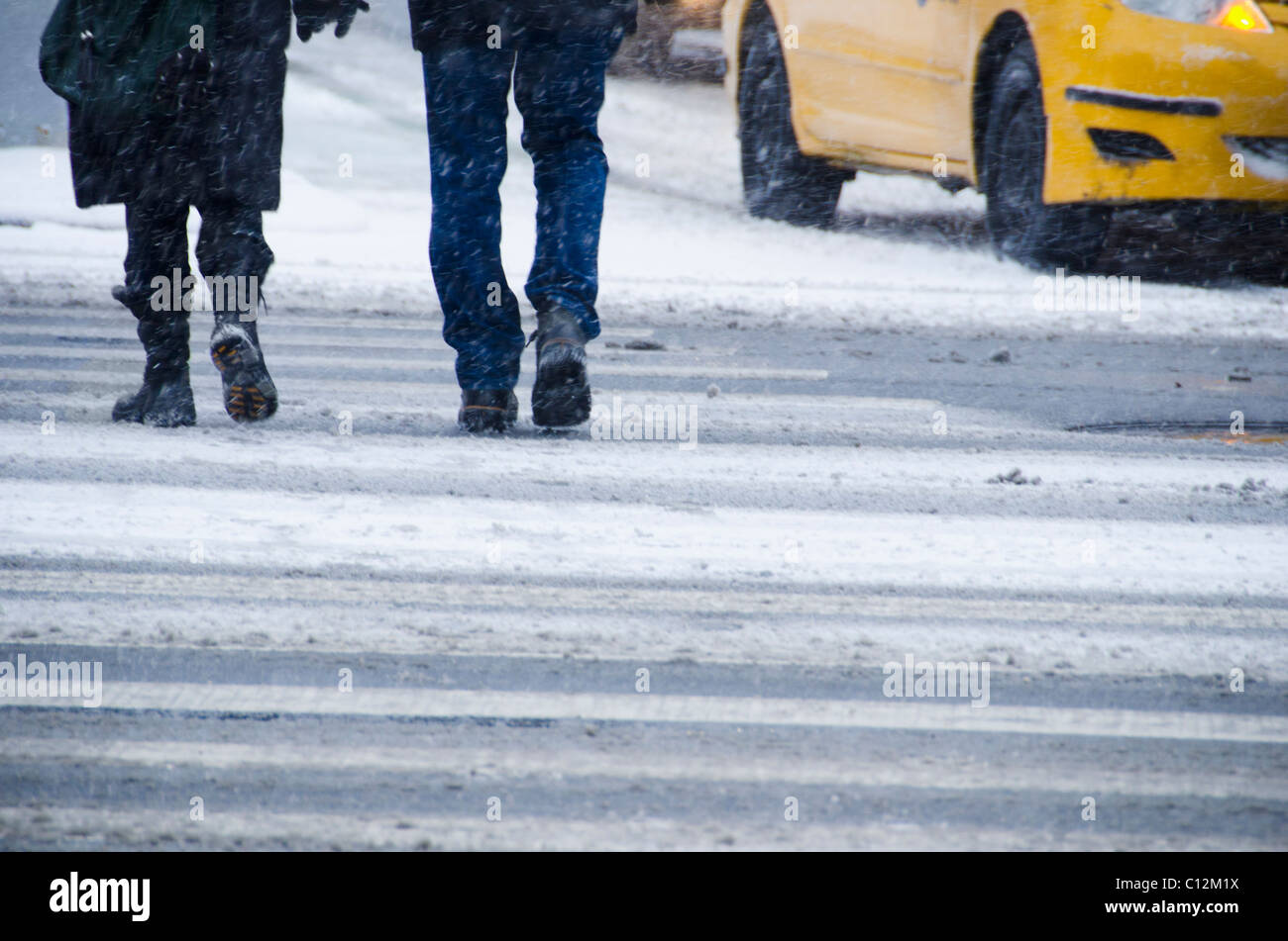 USA, New York City, Fußgänger beim Überqueren der Straße im blizzard Stockfoto
