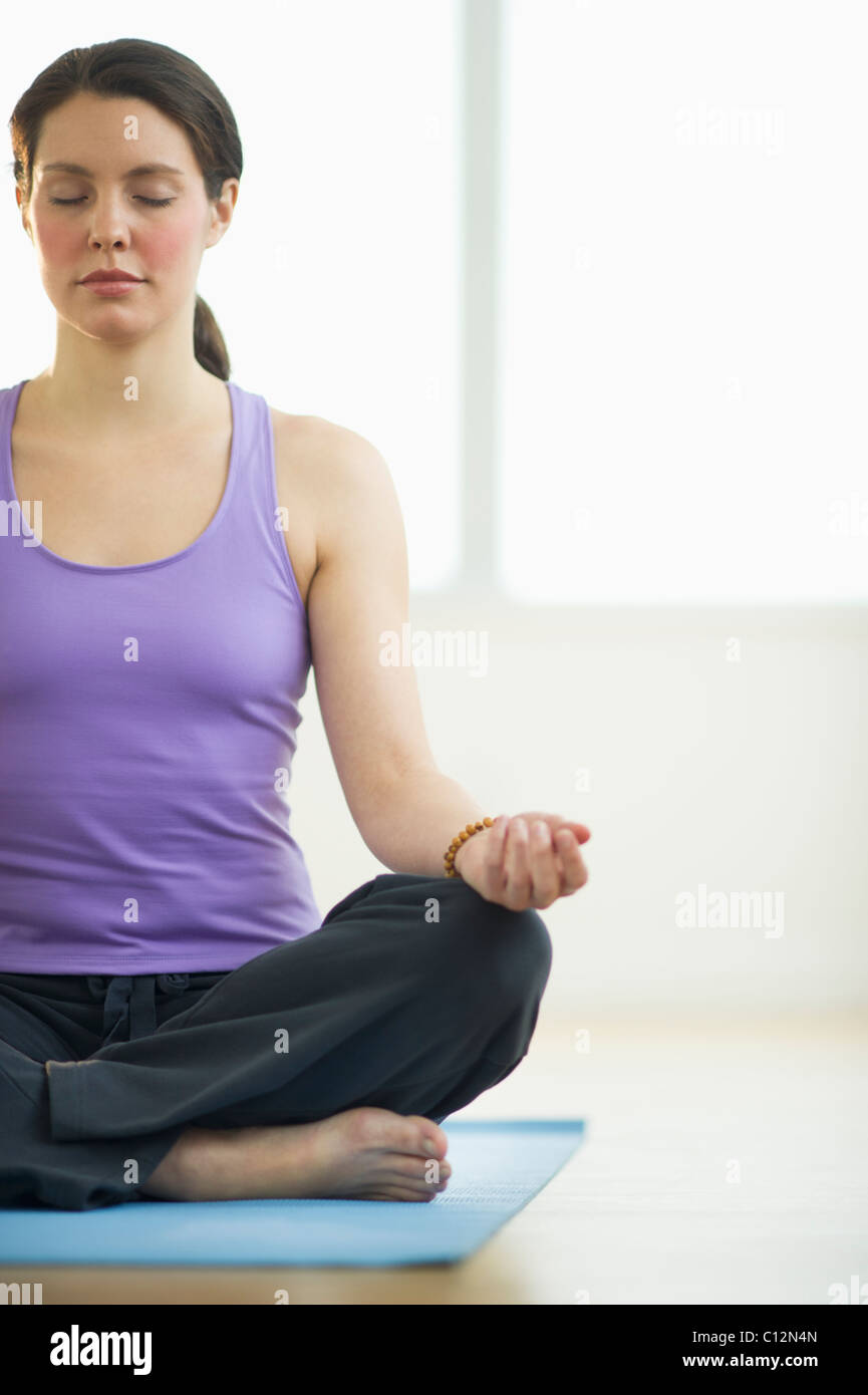 USA, New Jersey, Jersey City, junge Frau Meditation im Lotussitz Stockfoto
