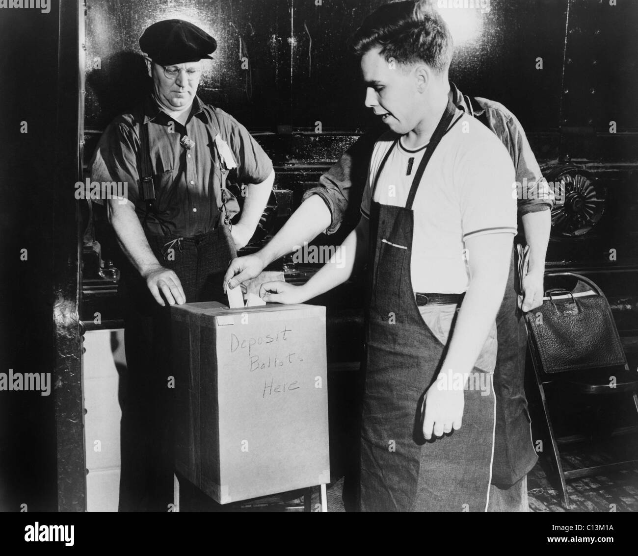 Arbeitnehmer, die Hinterlegung Stimmzettel während einer National Labor Relations Board-Wahl für gewerkschaftliche Vertretung im River Rouge Ford-Werk in Dearborn, Michigan. Juni 1941. Stockfoto