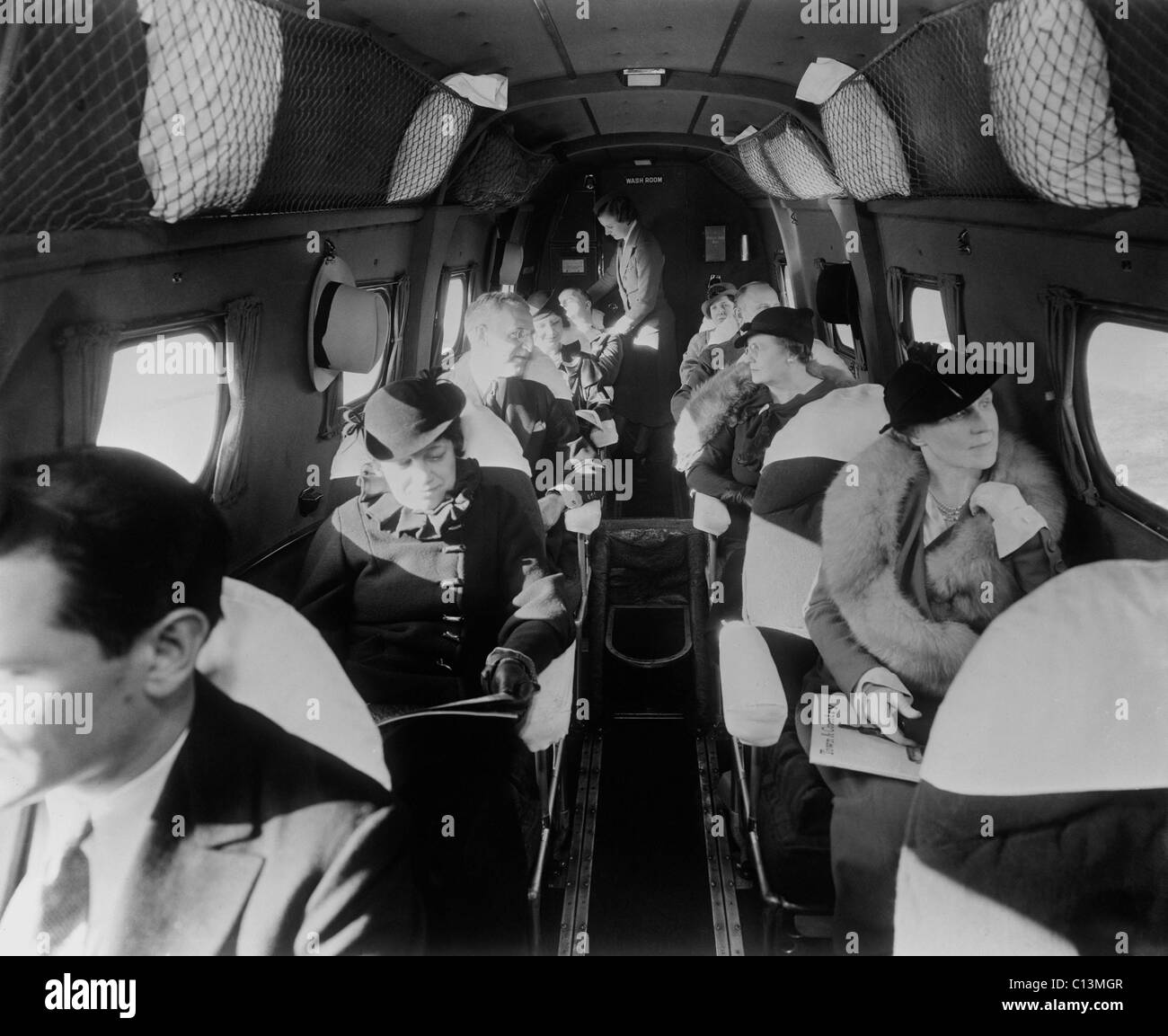 Stilvoll gekleidete Passagiere sitzen in einem kommerziellen Flug in den 1930er Jahren. LC-DIG-Hec-14562 Stockfoto