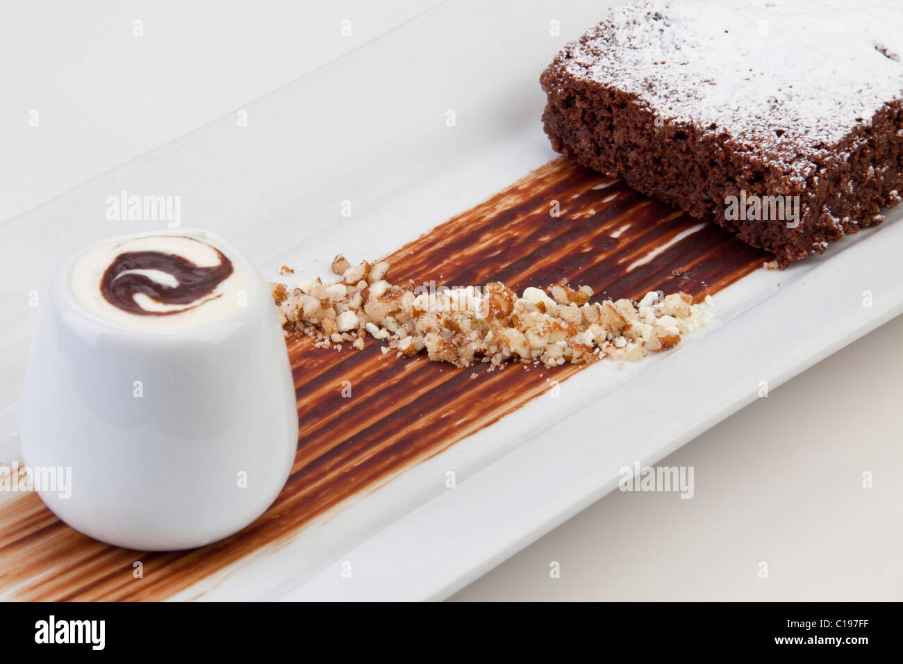 Süße Dessert: Schokoladen-Brownie mit Weinbrand Creme & karamellisierte Haselnuss garnieren 116487 Food Stockfoto