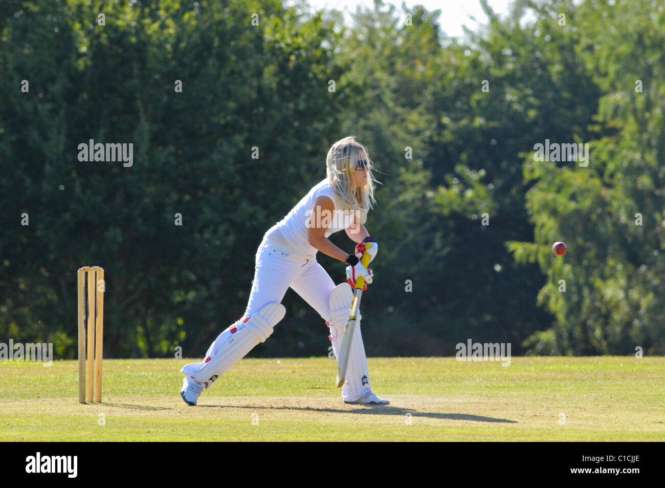 Frau in frühen zwanziger Jahren Cricket zum Spaß spielen. Stockfoto