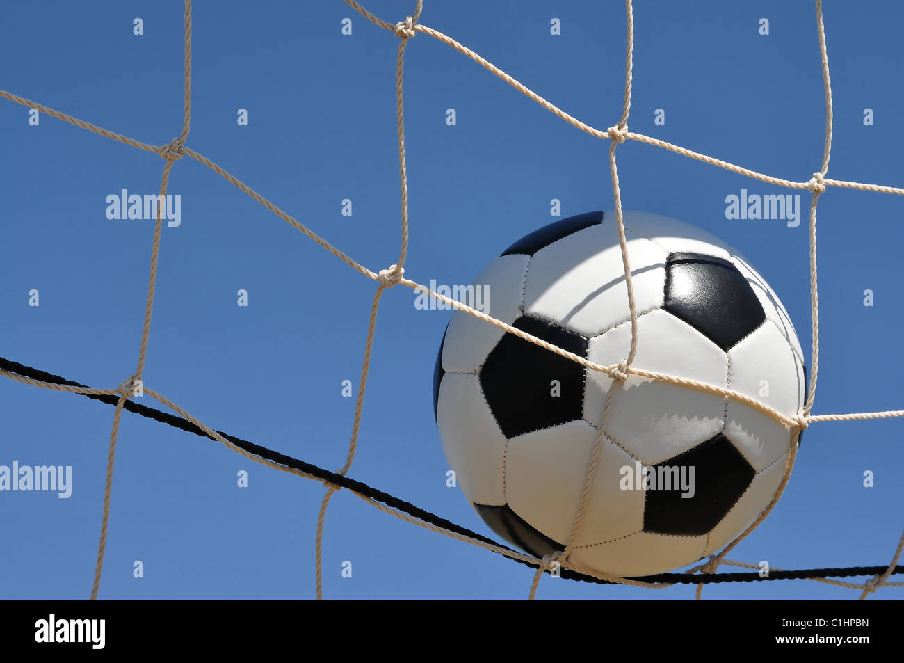 Fußball im Netz des Tores mit Textfreiraum. Stockfoto