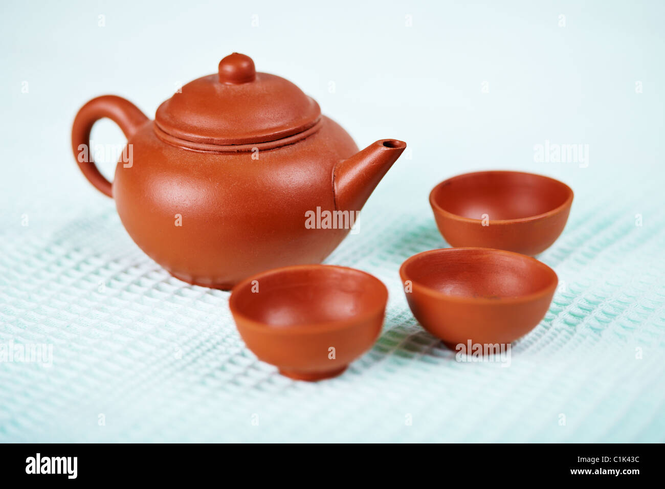 Keramik Teekanne und Tassen auf der Oberfläche ein blaues Handtuch Stockfoto