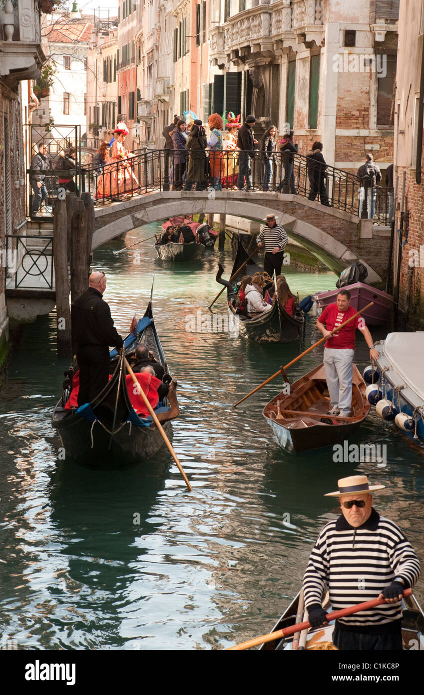 Gondeln unter beobachtet eine Brücke von Menschen in Kostüm, Karneval, Venedig, Italien Stockfoto