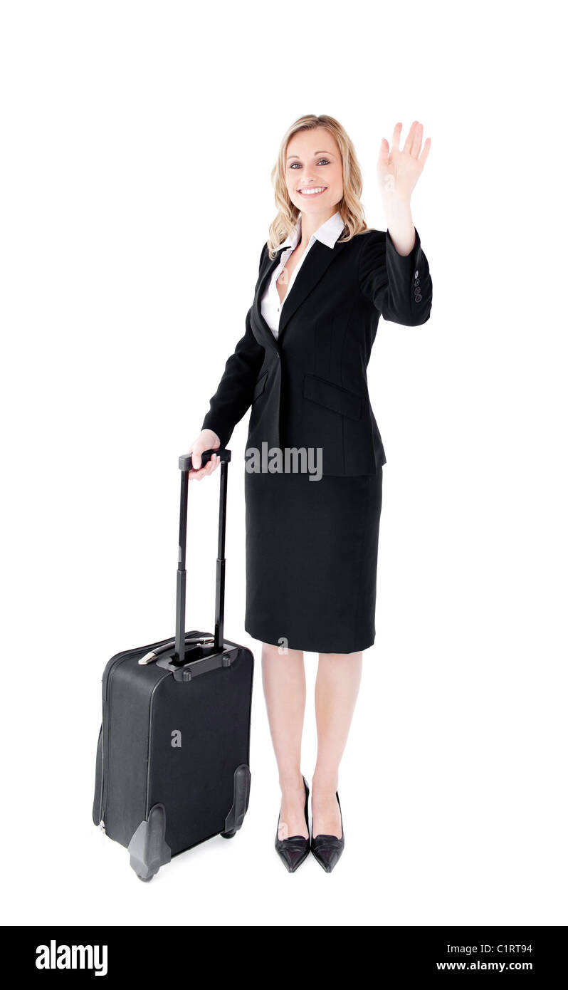 Begeistert junge Geschäftsfrau winken in die Kamera hält einen Koffer Stockfoto