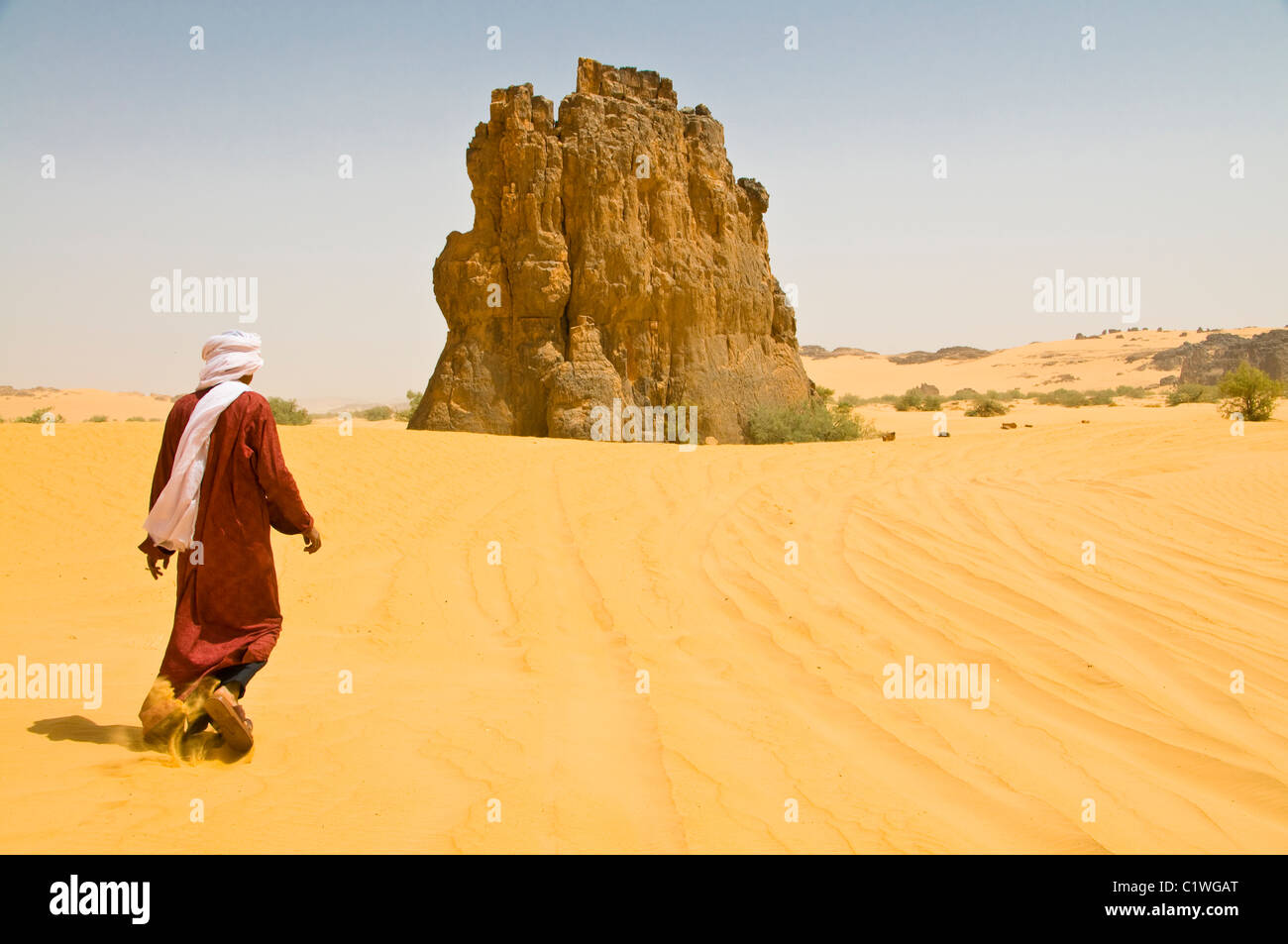 Algerien, La Vache Qui Pleure, Sahara, Mann zu Fuß in Richtung Rock in Sandwüste Stockfoto