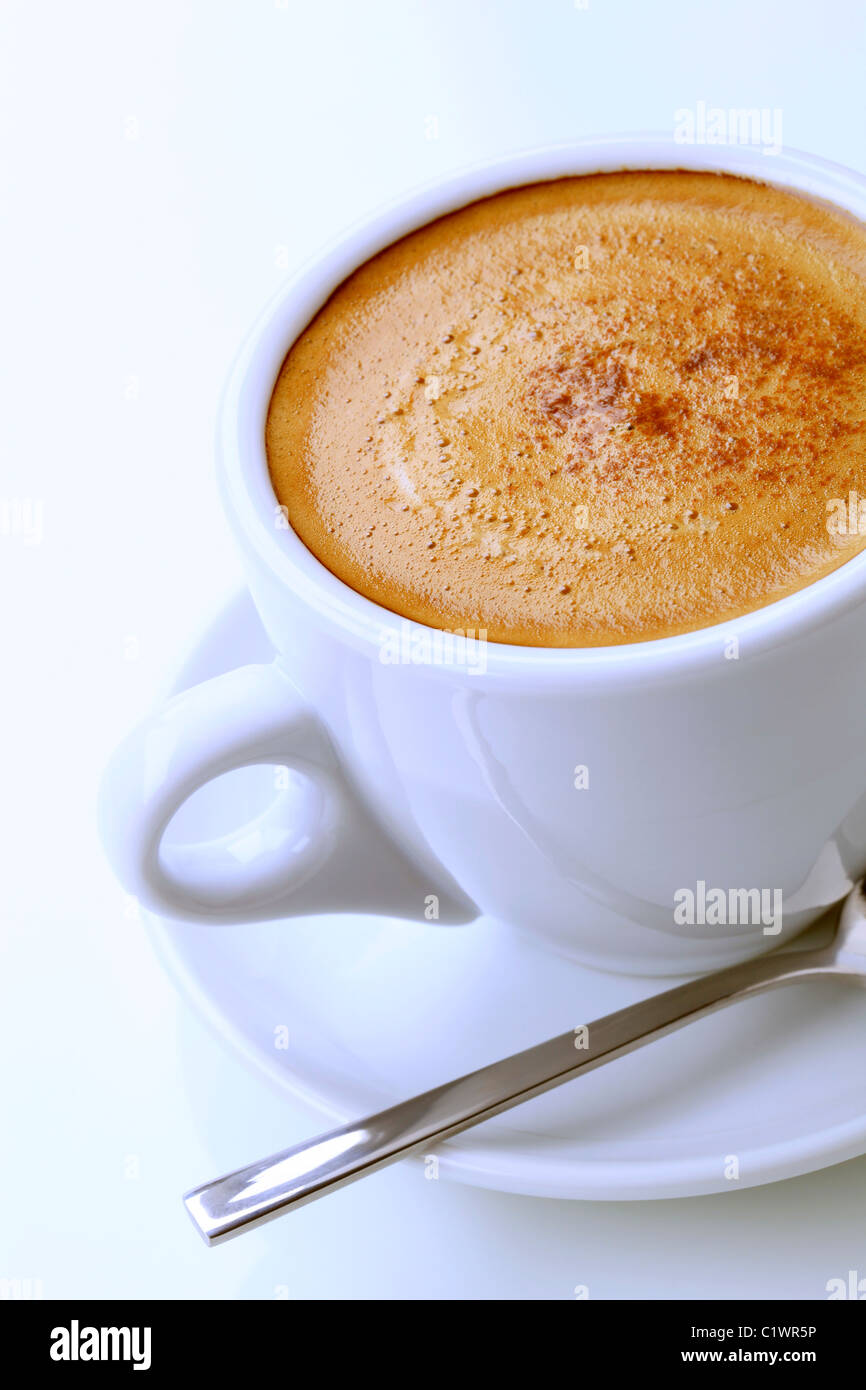 Tasse Kaffee mit Schaum und eine Prise Muskatnuss Stockfotografie