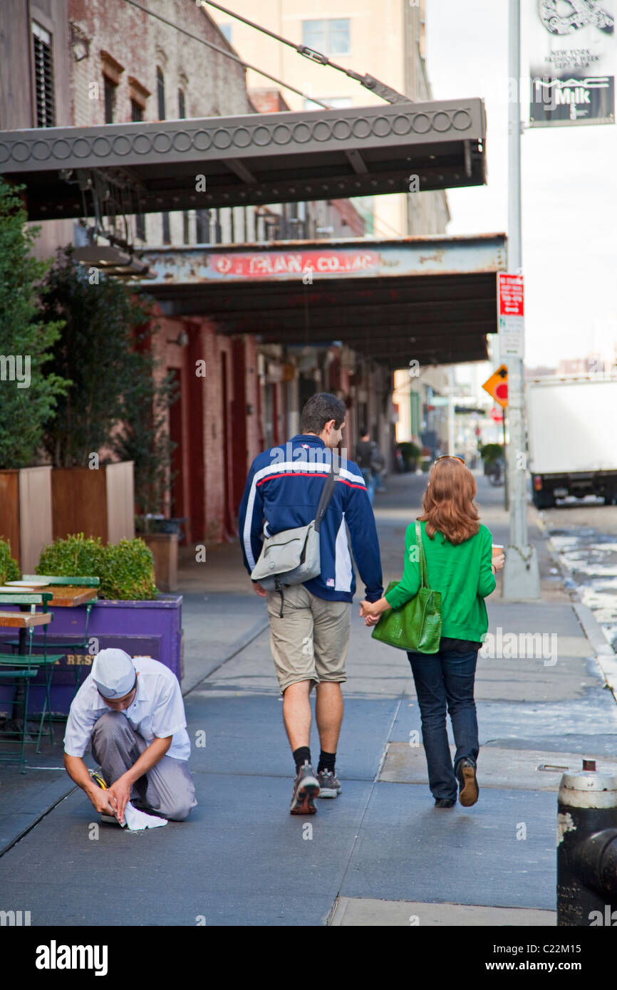 Paar zu Fuß hinunter Gansevoort Street, Meat Packing District, Greenwich Village, New York, USA Stockfoto