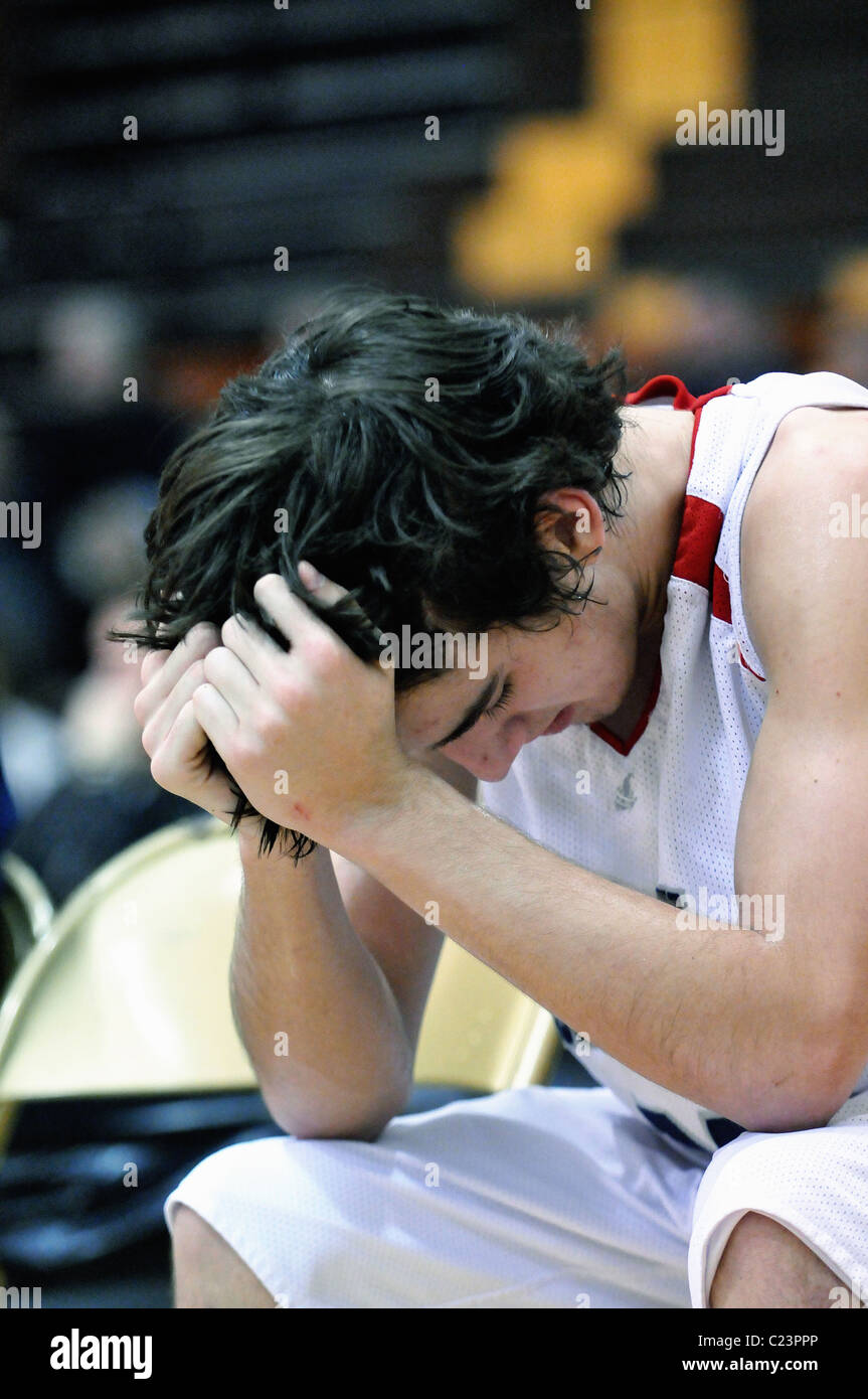 Oberstufenschüler hält den Kopf in seinen Händen, wie er kann nicht sehen, die letzten Sekunden ticken von der Uhr seine Saison beenden Stockfoto