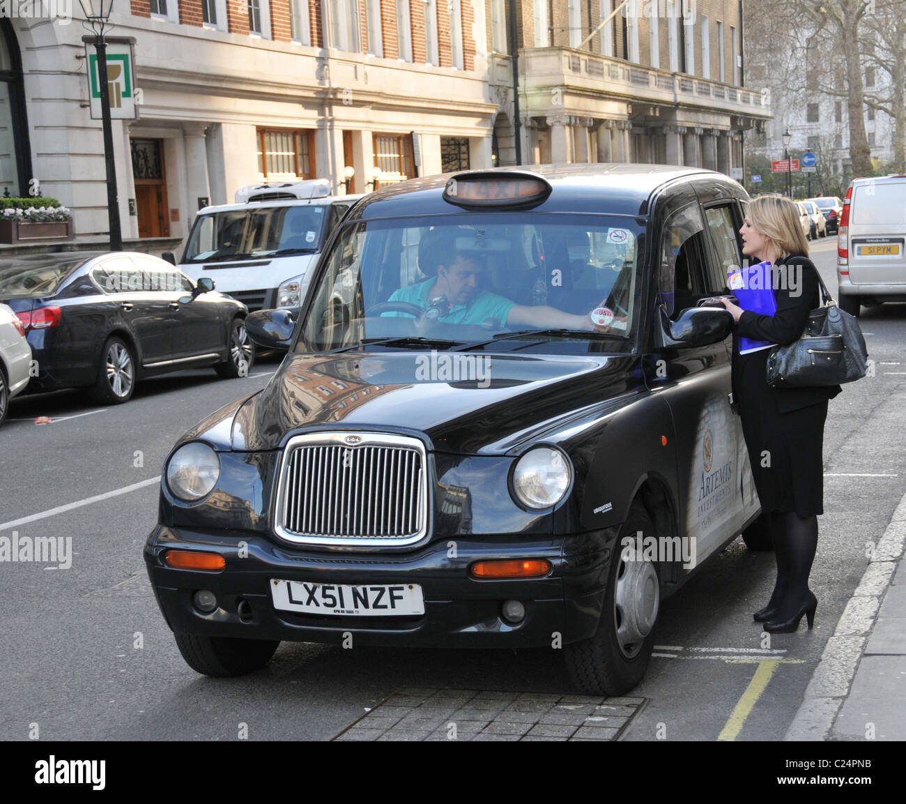 Business-Frau passt Frau London Taxi Passagier zahlt Tarif Reise Stockfoto