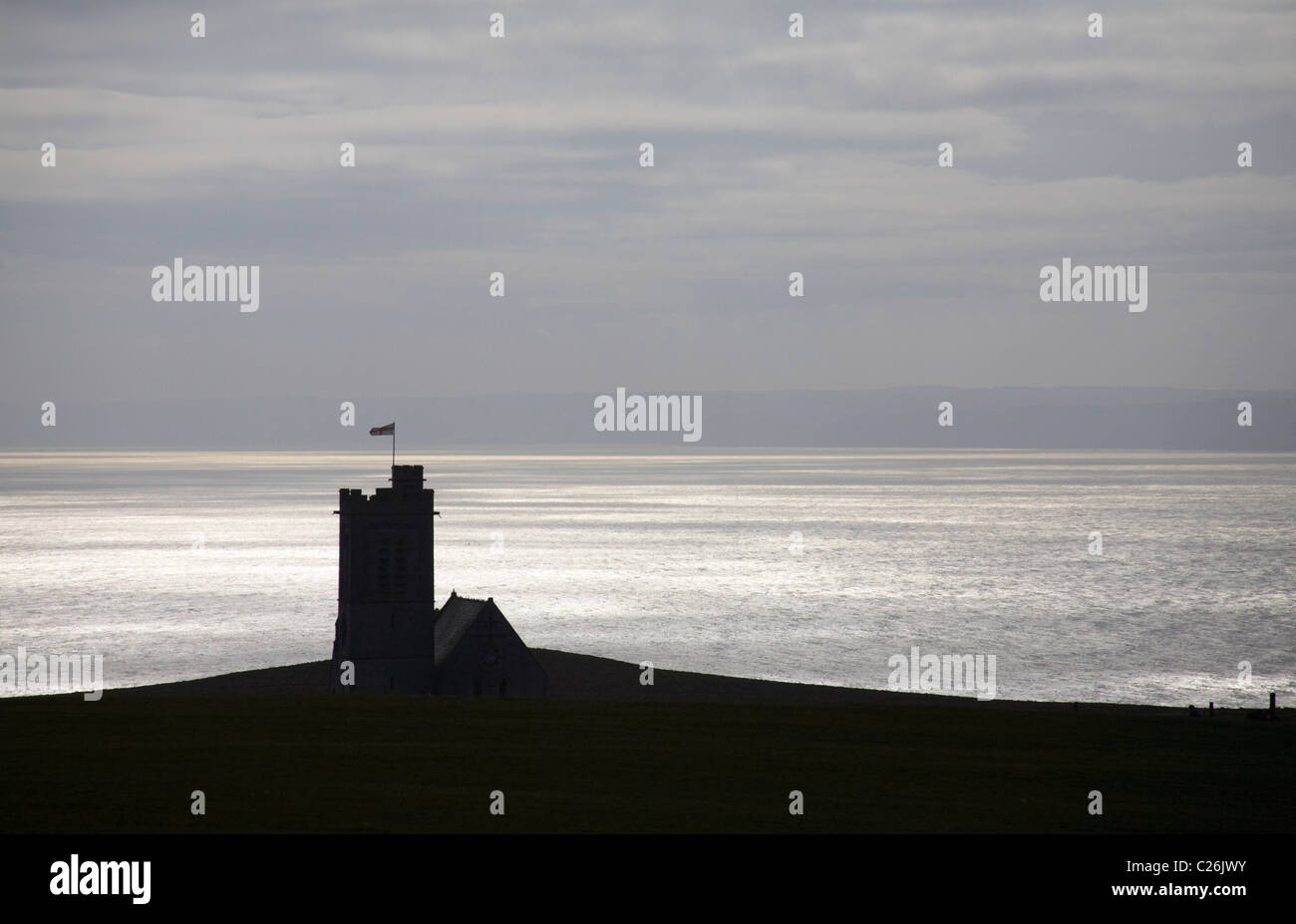 St. Helena Kirche Silhouette gegen den silbrigen Meere auf Lundy Island, Devon, England UK im März - St Helens Kirche Stockfoto
