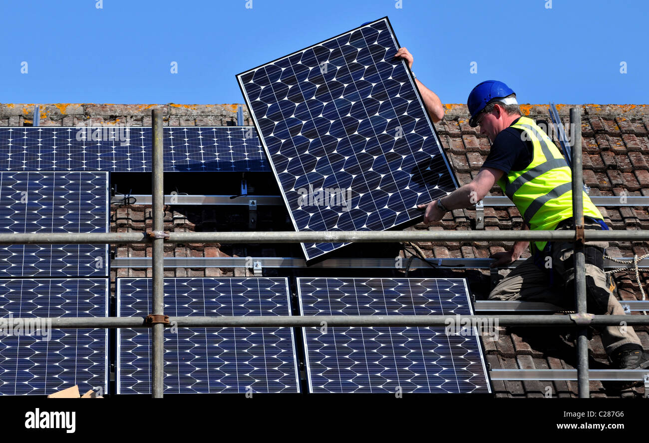 Sonnenkollektoren installiert wird, auf ein Haus Dach, England, UK Stockfoto