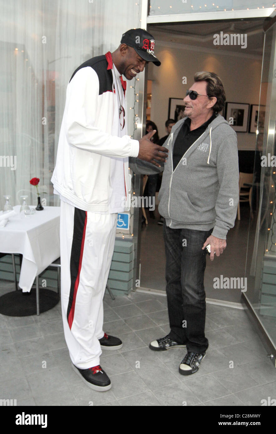 LA Laker D. J. Mbenga und Johnny Hallyday Johnny Hallyday und seine Frau Laetitia, zu Mittag mit LA Laker D. J. Mbenga an Stockfoto